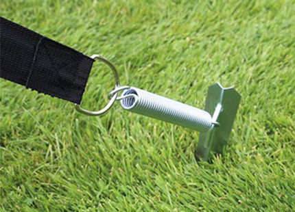 Awning Tie Down Kit mechanism with spring in grass