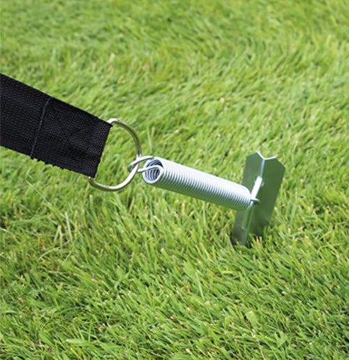 Awning Tie Down Kit mechanism with spring in grass